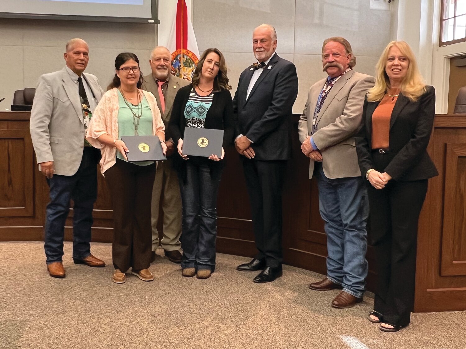 OKEECHOBEE --Pauline Daniel and Tiffany Gould were honored at the Oct. 26 meeting of the Okeechobee County Commission. Left to right are Commission Chairman David Hazellief, Daniel, Commissioner Frank DeCarlo, Gould, Commissioner Terry Burroughs, Commissioner Brad Goodbread and County Manager Deborah Manzo.